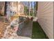 Backyard with terraced landscaping, hardscaping, and grilling area at 539 Riverbirch Trce, Stone Mountain, GA 30087