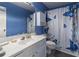 Bright bathroom featuring a white vanity, toilet, and butterfly themed shower curtain at 539 Riverbirch Trce, Stone Mountain, GA 30087