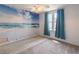 Cozy bedroom with beach mural, neutral carpet, and window with blue curtains at 539 Riverbirch Trce, Stone Mountain, GA 30087