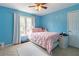 Charming bedroom with bright blue walls, a pink bed, and lots of natural light at 539 Riverbirch Trce, Stone Mountain, GA 30087