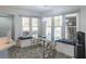 Dining area with stylish glass table, cushioned benches, and plenty of natural light at 539 Riverbirch Trce, Stone Mountain, GA 30087