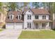 Charming two-story home with a three car garage, covered porch, and landscaped front yard at 539 Riverbirch Trce, Stone Mountain, GA 30087