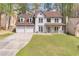 Charming two-story home with a three car garage, covered porch, and landscaped front yard at 539 Riverbirch Trce, Stone Mountain, GA 30087