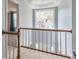 Upstairs hallway featuring a large window and railings with a view to the foyer at 539 Riverbirch Trce, Stone Mountain, GA 30087