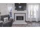 Cozy living room featuring a fireplace with stone surround and a wall-mounted television at 539 Riverbirch Trce, Stone Mountain, GA 30087