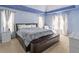 Spacious bedroom features a blue tray ceiling, plush carpet, and large windows at 539 Riverbirch Trce, Stone Mountain, GA 30087