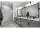 This spacious bathroom features a double vanity, large mirror, and a walk-in shower at 825 Maplewood Dr, Roswell, GA 30075