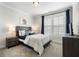 Cozy bedroom with a large window, a comfortable bed, and a modern television at 825 Maplewood Dr, Roswell, GA 30075