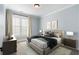 Bright bedroom with a large window, soft carpet, and neutral colors for a relaxing atmosphere at 825 Maplewood Dr, Roswell, GA 30075