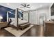 Spacious bedroom featuring a canopy bed, hardwood floors, and natural light from windows at 825 Maplewood Dr, Roswell, GA 30075