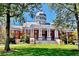 City Hall building featuring white columns, a dome, and well-maintained landscaping in a sunny day at 825 Maplewood Dr, Roswell, GA 30075
