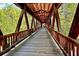 Interior view of a long wooden covered bridge with timber framing and a rustic charm at 825 Maplewood Dr, Roswell, GA 30075
