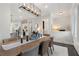 Open concept dining room with shuttered doors, hardwood floors and modern lighting at 825 Maplewood Dr, Roswell, GA 30075