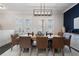 Elegant dining room featuring a modern chandelier, stylish furniture, and a sophisticated color palette at 825 Maplewood Dr, Roswell, GA 30075