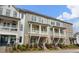 Charming townhomes with brick accents, inviting porches, and meticulously manicured landscaping at 825 Maplewood Dr, Roswell, GA 30075