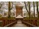 Picturesque brick building framed by trees and a walking bridge, creating an inviting and tranquil setting at 825 Maplewood Dr, Roswell, GA 30075