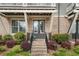 Charming front entrance with brick steps, a covered porch, manicured landscaping, and a welcoming atmosphere at 825 Maplewood Dr, Roswell, GA 30075