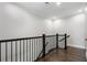 Upstairs hallway with wooden floors and iron railing at 825 Maplewood Dr, Roswell, GA 30075