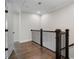 Upstairs hallway features dark wood banister and hardwood floors, bathed in natural light at 825 Maplewood Dr, Roswell, GA 30075