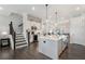 Elegant kitchen with an island, stainless steel appliances, and white cabinets, situated near a staircase and pantry at 825 Maplewood Dr, Roswell, GA 30075