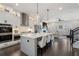 Bright kitchen with white cabinets, stainless steel appliances, a large island, and an open view to the living space at 825 Maplewood Dr, Roswell, GA 30075