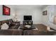 Comfortable living room with hardwood floors, plush leather sofa, and television area at 825 Maplewood Dr, Roswell, GA 30075