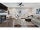 Cozy living room with a fireplace, built-in shelving, and comfortable seating, with double doors leading to the outside at 825 Maplewood Dr, Roswell, GA 30075