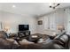 Comfortable living room with hardwood floors, plush leather sofa, and access to outdoor patio at 825 Maplewood Dr, Roswell, GA 30075