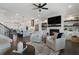 Cozy living room showcasing a fireplace, built-in shelving, and views of the kitchen at 825 Maplewood Dr, Roswell, GA 30075
