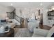Well-lit living room with stairs, neutral furniture, and an open floor plan to the kitchen at 825 Maplewood Dr, Roswell, GA 30075