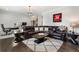 Inviting living area with hardwood floors, plush leather sofa, and well-lit office space at 825 Maplewood Dr, Roswell, GA 30075