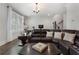 Inviting living area with hardwood floors, plush leather sofa, and well-lit office space at 825 Maplewood Dr, Roswell, GA 30075