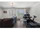 Cozy living room with hardwood floors, plush leather sofa, and natural light from French doors at 825 Maplewood Dr, Roswell, GA 30075