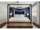 Beautiful main bedroom with a canopy bed, dark accent wall, and wood floors at 825 Maplewood Dr, Roswell, GA 30075
