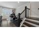 Bright home office featuring a staircase, dark wood floors, and modern exercise equipment at 825 Maplewood Dr, Roswell, GA 30075