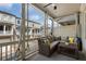 Comfortable porch with cushioned seating and views of neighboring homes and blue skies at 825 Maplewood Dr, Roswell, GA 30075