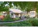 Charming restaurant exterior with a wooden sign, inviting walkway, and lush landscaping at 825 Maplewood Dr, Roswell, GA 30075