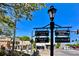 Charming street sign pointing towards local shops, the visitor center, and city hall at 825 Maplewood Dr, Roswell, GA 30075