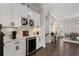 Stylish wet bar features a wine rack, beverage cooler, and ample counter space, situated near a staircase and dining area at 825 Maplewood Dr, Roswell, GA 30075
