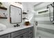 Stylish bathroom featuring a glass-enclosed shower with gray vanity and decorative wall tiles at 2328 Mason Drive Dr, Atlanta, GA 30316