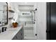 Modern bathroom featuring a glass-enclosed shower with a gray vanity and floating shelves at 2328 Mason Drive Dr, Atlanta, GA 30316