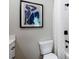 Modern bathroom featuring a toilet, tiled shower, and an artistic picture on the wall at 2328 Mason Drive Dr, Atlanta, GA 30316