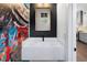 Stylish powder room with quartz countertop and a gold framed mirror, complemented by unique graffiti art at 2328 Mason Drive Dr, Atlanta, GA 30316