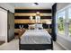 Stylish bedroom with an accent wall, large window, and a sliding barn door that leads to the ensuite at 2328 Mason Drive Dr, Atlanta, GA 30316