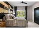 Inviting bedroom with wood paneling, black accents, and natural light streaming through the large window at 2328 Mason Drive Dr, Atlanta, GA 30316
