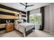 Charming bedroom featuring a stylish wood accent wall and a large window with leafy outdoor views at 2328 Mason Drive Dr, Atlanta, GA 30316