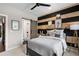 Cozy bedroom features a black and wood accent wall, black ceiling fan and ensuite bathroom at 2328 Mason Drive Dr, Atlanta, GA 30316