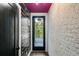 Hallway with decorative writing wall, brick accent, purple ceiling, and exterior view at 2328 Mason Drive Dr, Atlanta, GA 30316