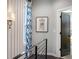 Hallway with iron railing, patterned drapes by the window, and stylish wall-mounted lighting at 2328 Mason Drive Dr, Atlanta, GA 30316