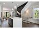 Stylish kitchen with a large island, modern lighting, and staircase at 2328 Mason Drive Dr, Atlanta, GA 30316